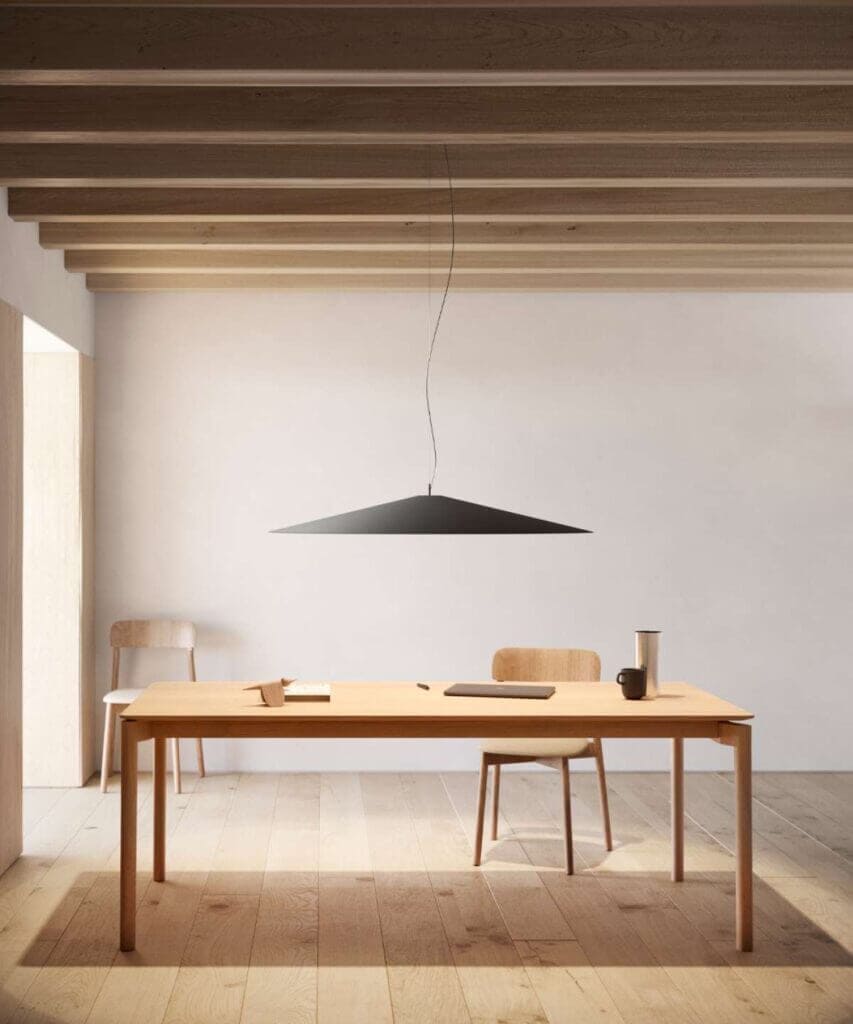 Luceplan Koine pendant in black above a dining table