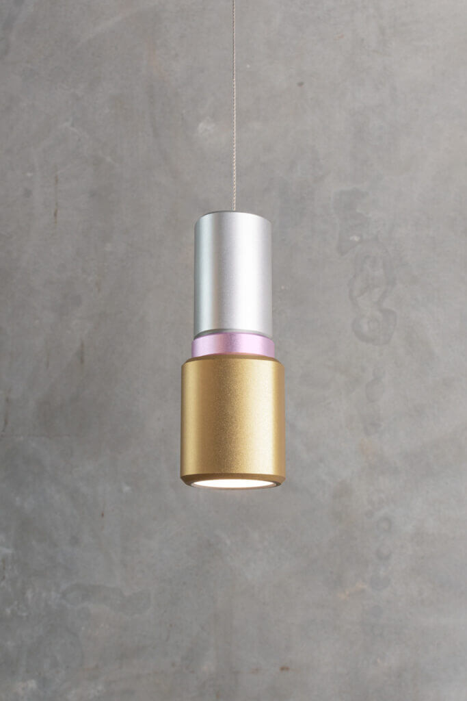 A-N-D Light Lobe pendant in silver and gold on a grey background