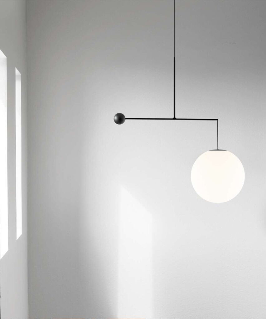 Luceplan Malamata wall light in black, globe shade on a white wall