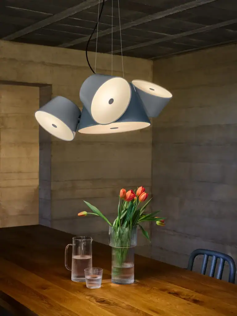 Marset Tam Tam pendant cluster in blue and white above a wood dining table