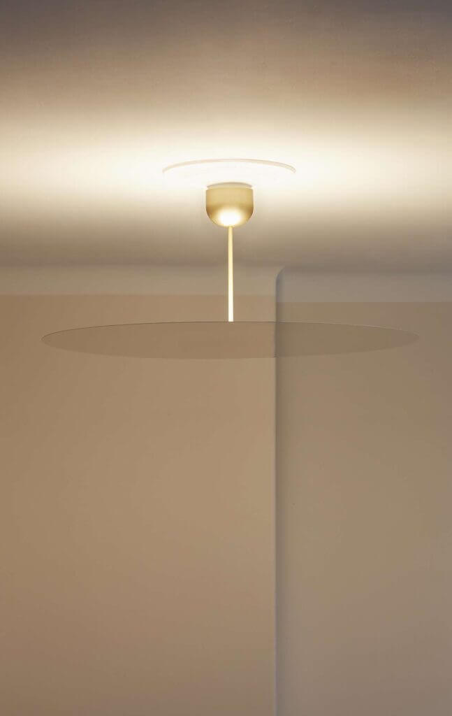 Luceplan Millimetro pendant, lit disc with a visible drop stem in a corner
