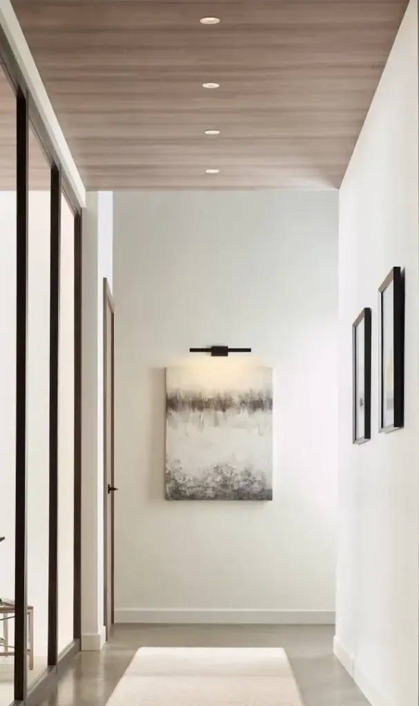 Visual Comfort & Co. Entra downlight along a wood ceiling hallway
