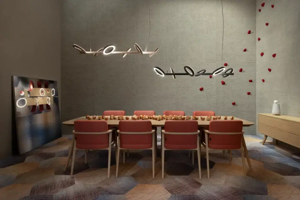 Moooi Pallana pendant, lit rings above a dining table with red chairs