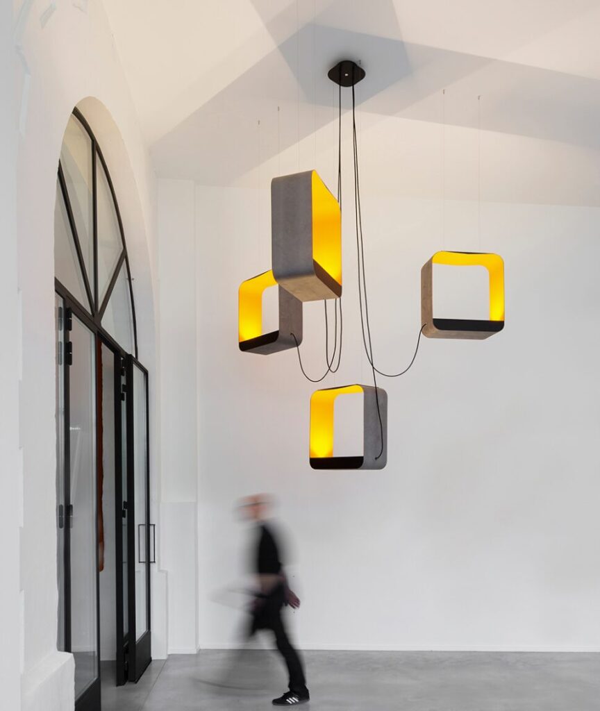 Designheure Eau de Lumière pendant, grey and yellow cube cluster lit near an entryway