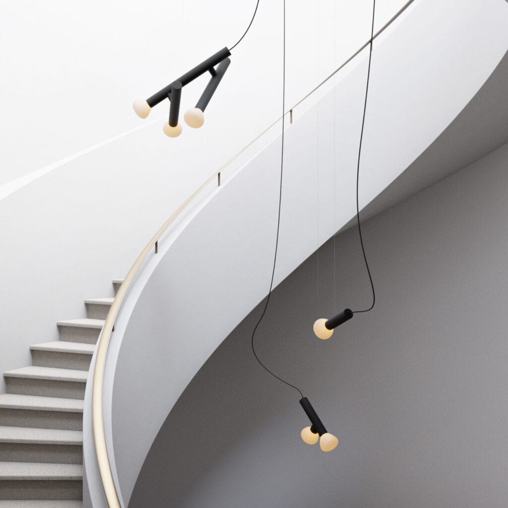 Lambert et Fils Parc pendant, angled fixtures lit beside a spiral staircase