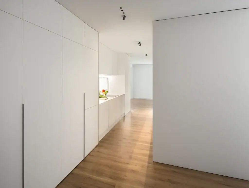 Flos Light Shadow Dots downlight in a white hallway with wood flooring