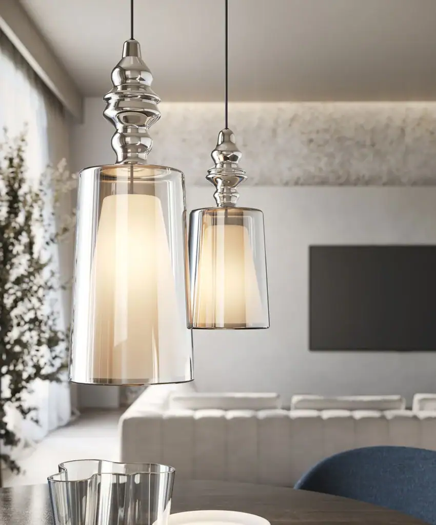 Karman Alibaglass pendant in chrome, above a living room seating area
