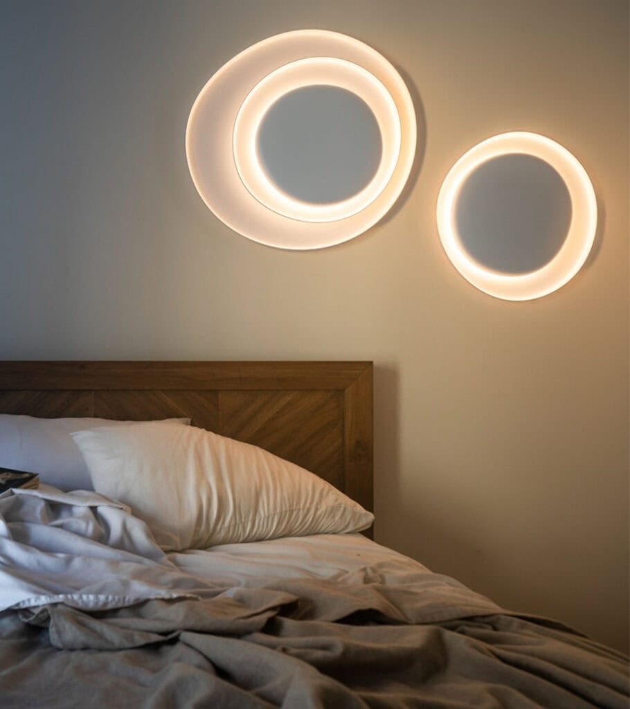 Foscarini Bahia wall light, two ring fixtures lit above a bed