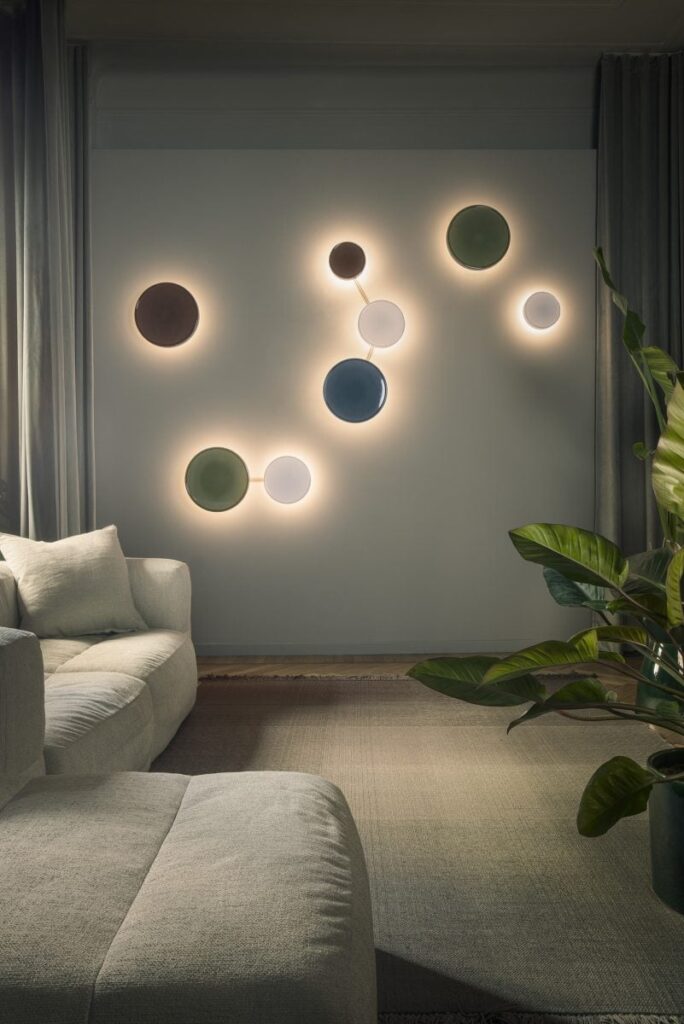 Decorative circular wall lights with backlit glow in a modern living room.