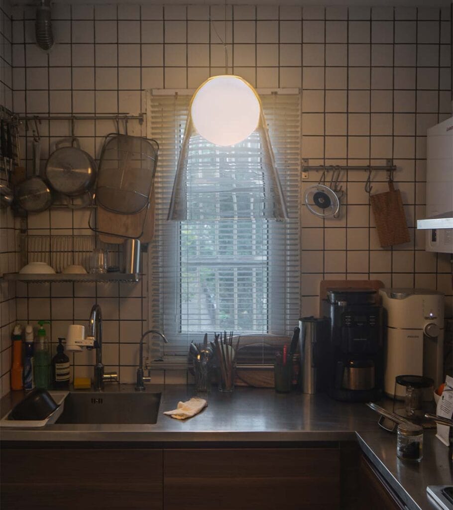 Foscarini Satellight pendant lit above a kitchen counter