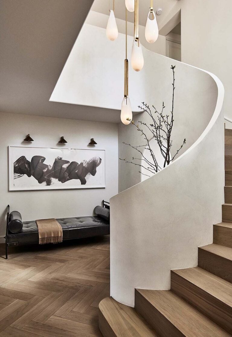 SkLO Hold Pin pendants in white glass hanging in a curved stairwell