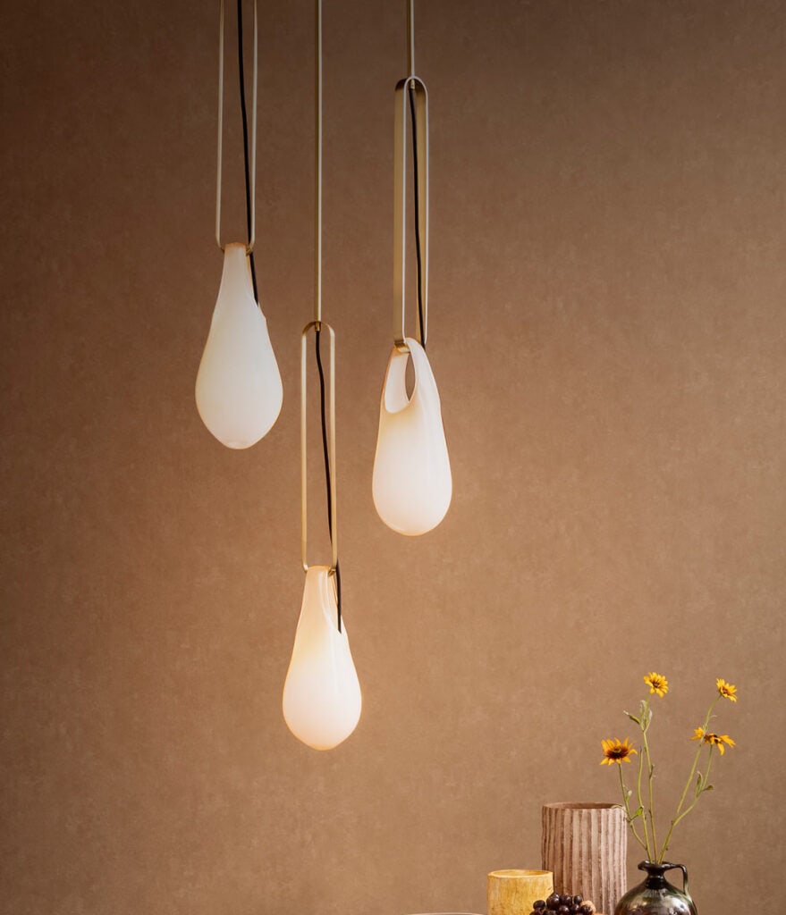 Modern pendant lights with teardrop-shaped white glass shades.