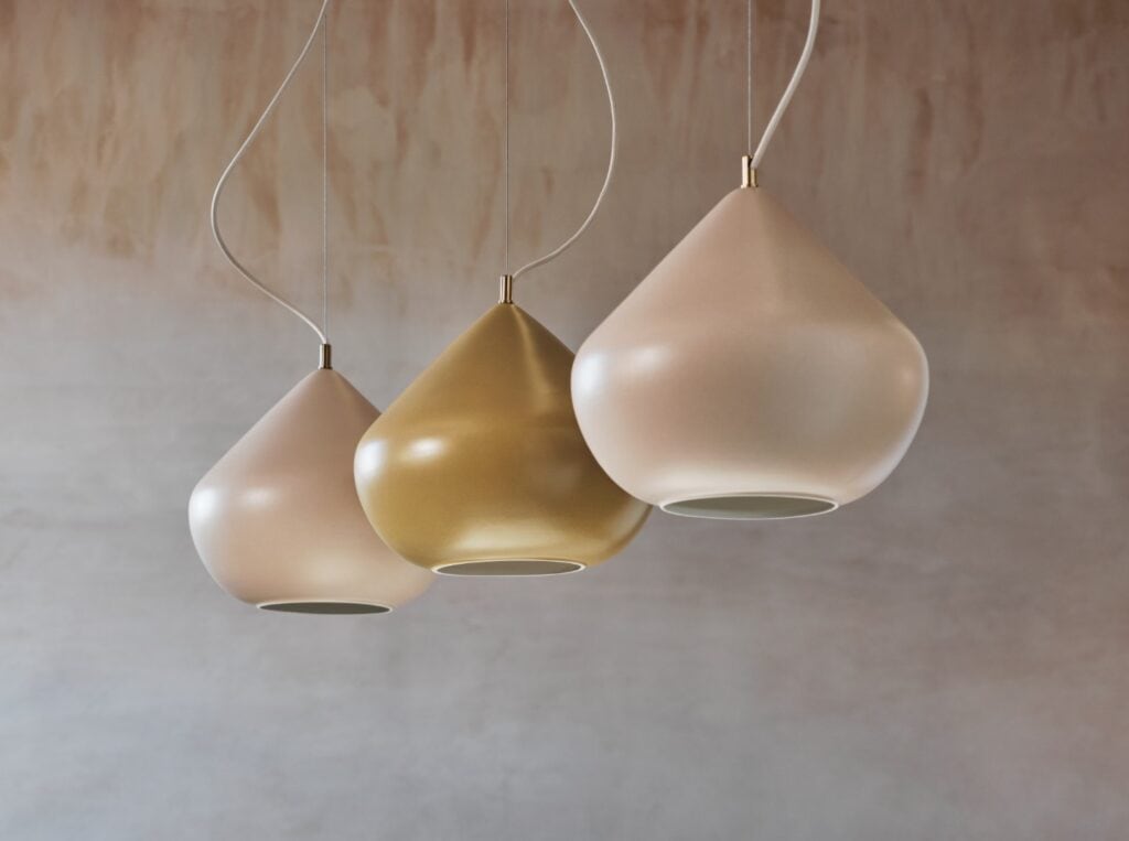 Modern pendant lights in soft beige and gold tones.