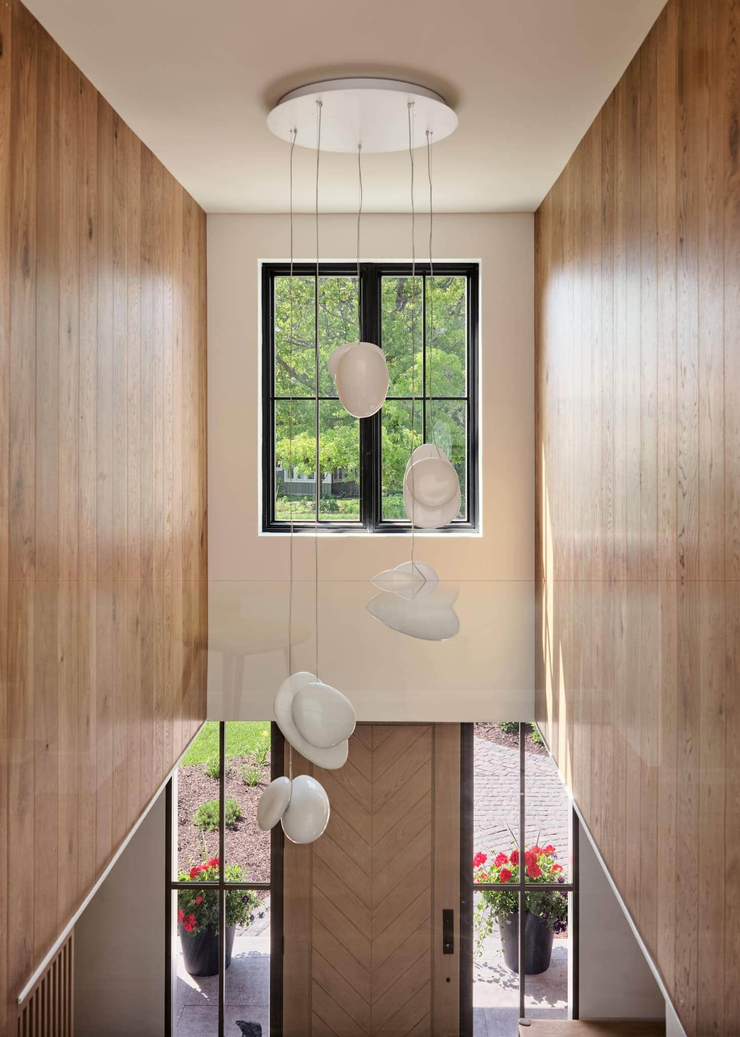 White globe pendants descending a bright stairwell