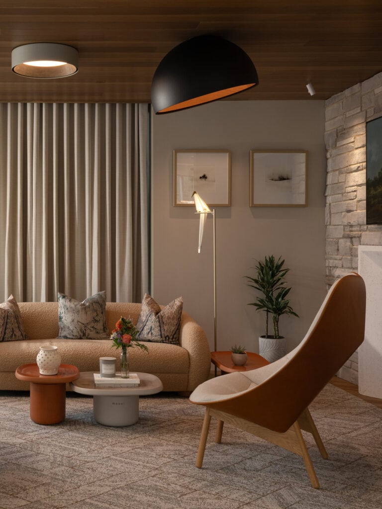 The living room at the Flux showroom in Ottawa, with automated Lutron drapery beside the glazing and layered warm lighting