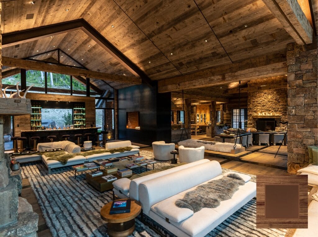 Warm wood-and-stone great room with Sonance architectural speakers concealed in the ceiling