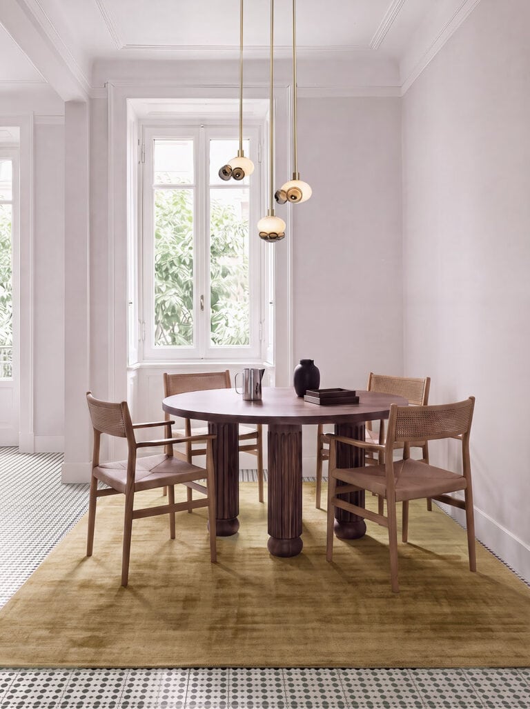 SkLO Bloom pendants above a round dining table by a tall window