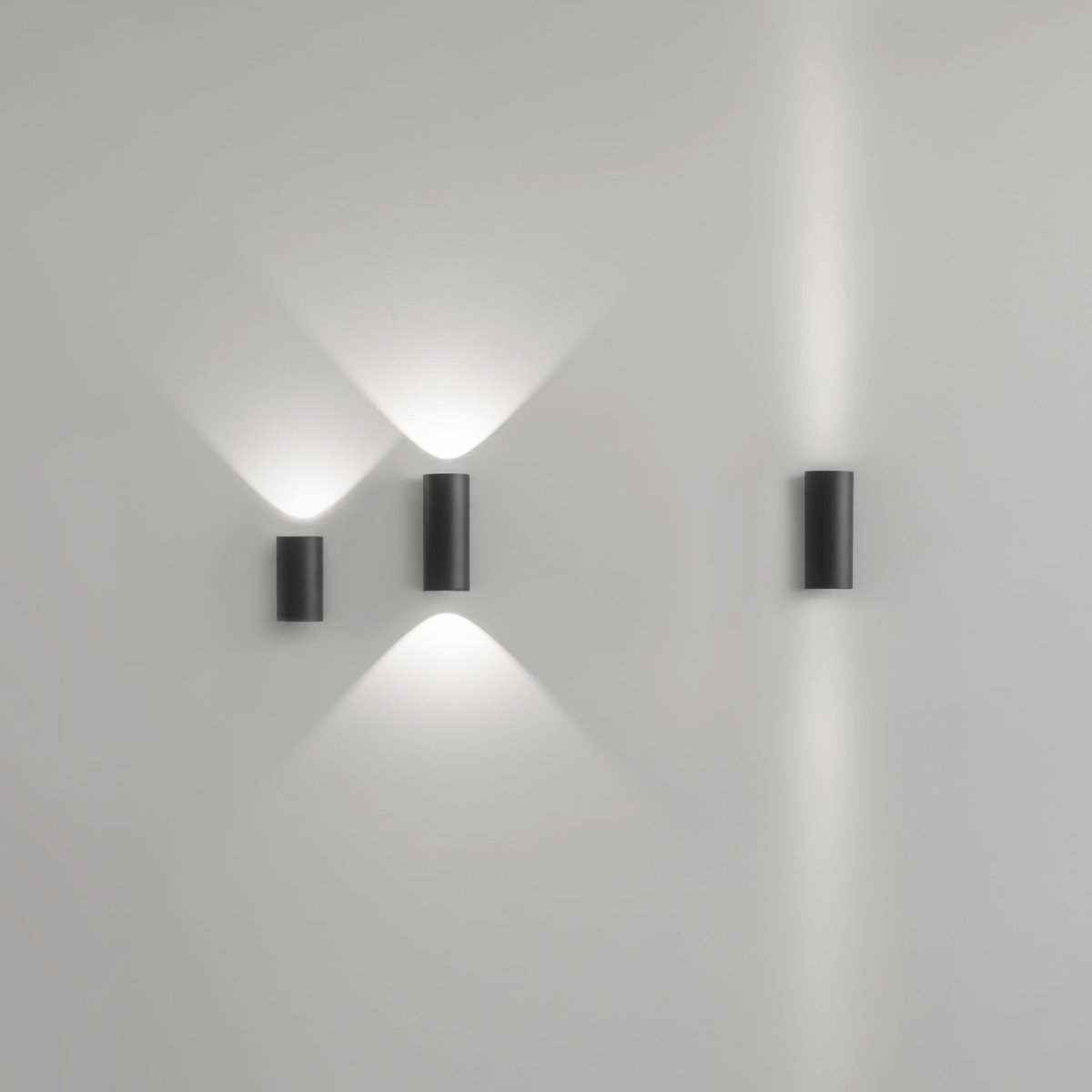 Black Delta Light Nocta wall lights casting light up and down a white wall