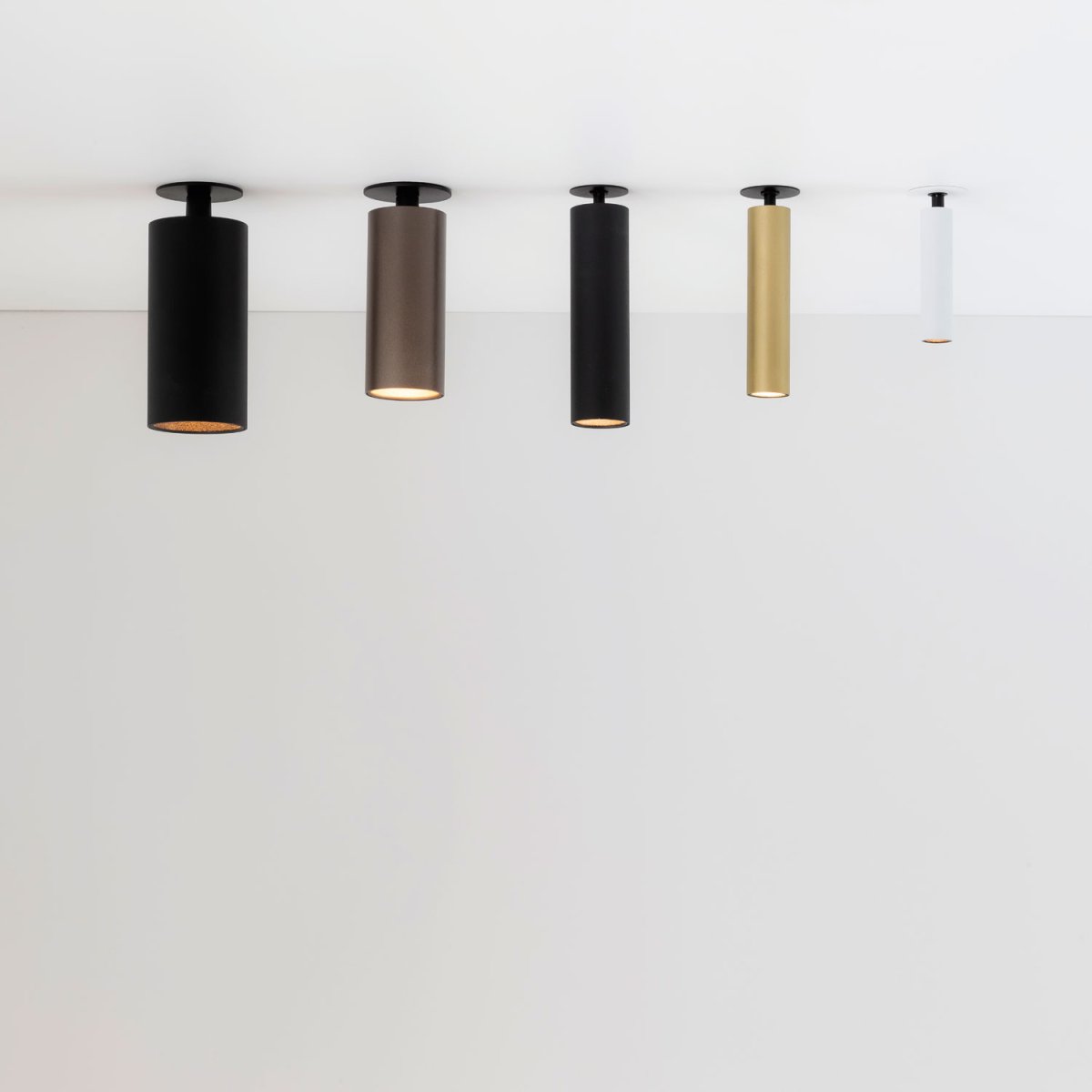 Delta Light Spy spotlights in a row of finishes hanging from a white ceiling